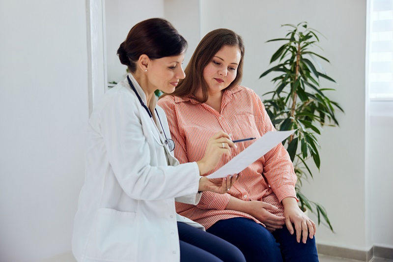 Woman talking to OB/GYN specialist.