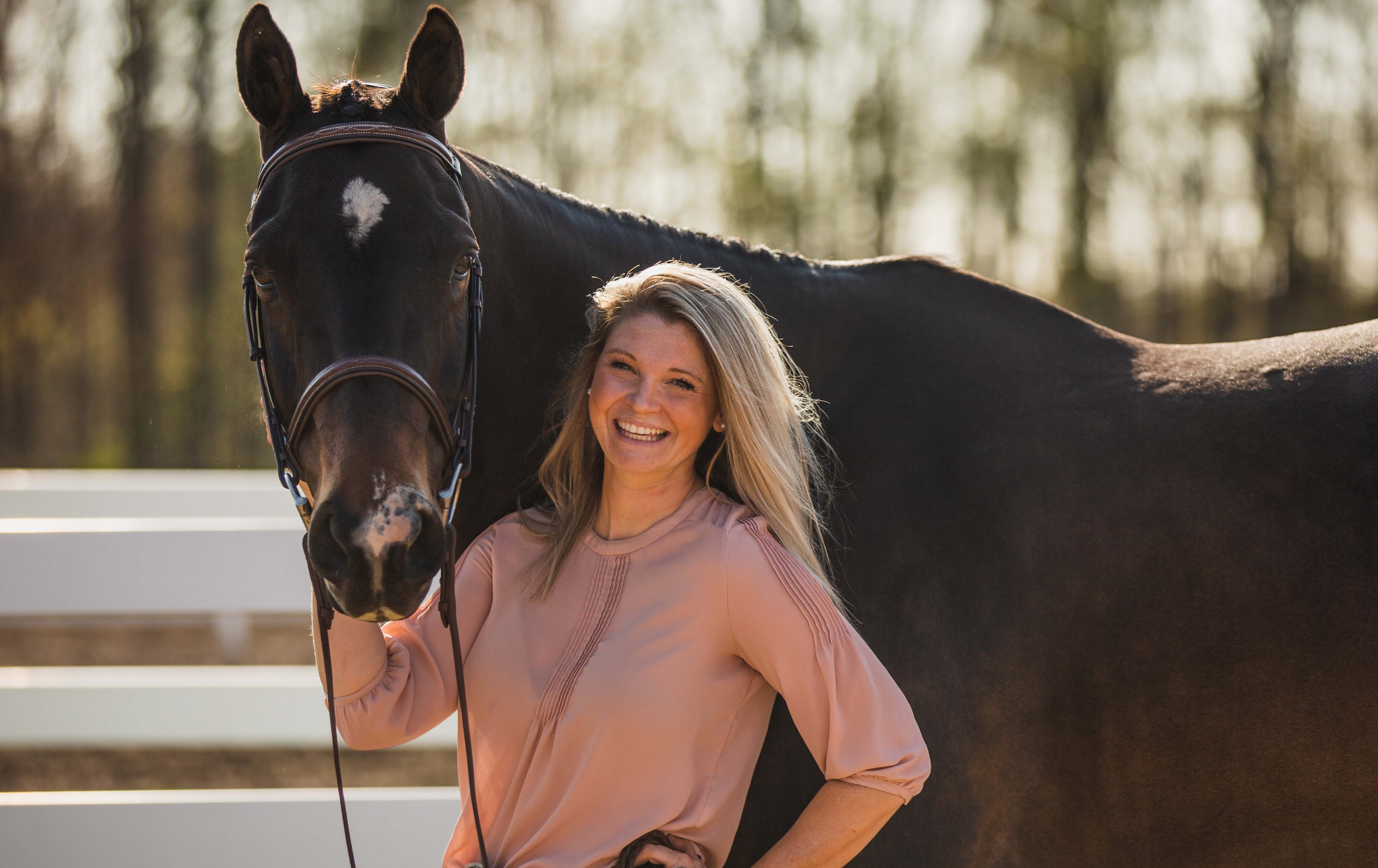 Katie standing with her horse