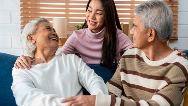 younger daughter with aged parents in living room