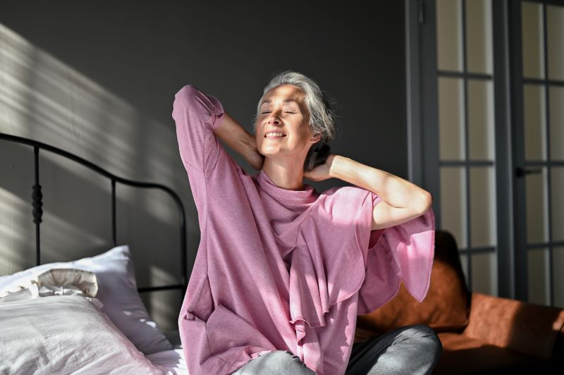 woman waking up and stretching